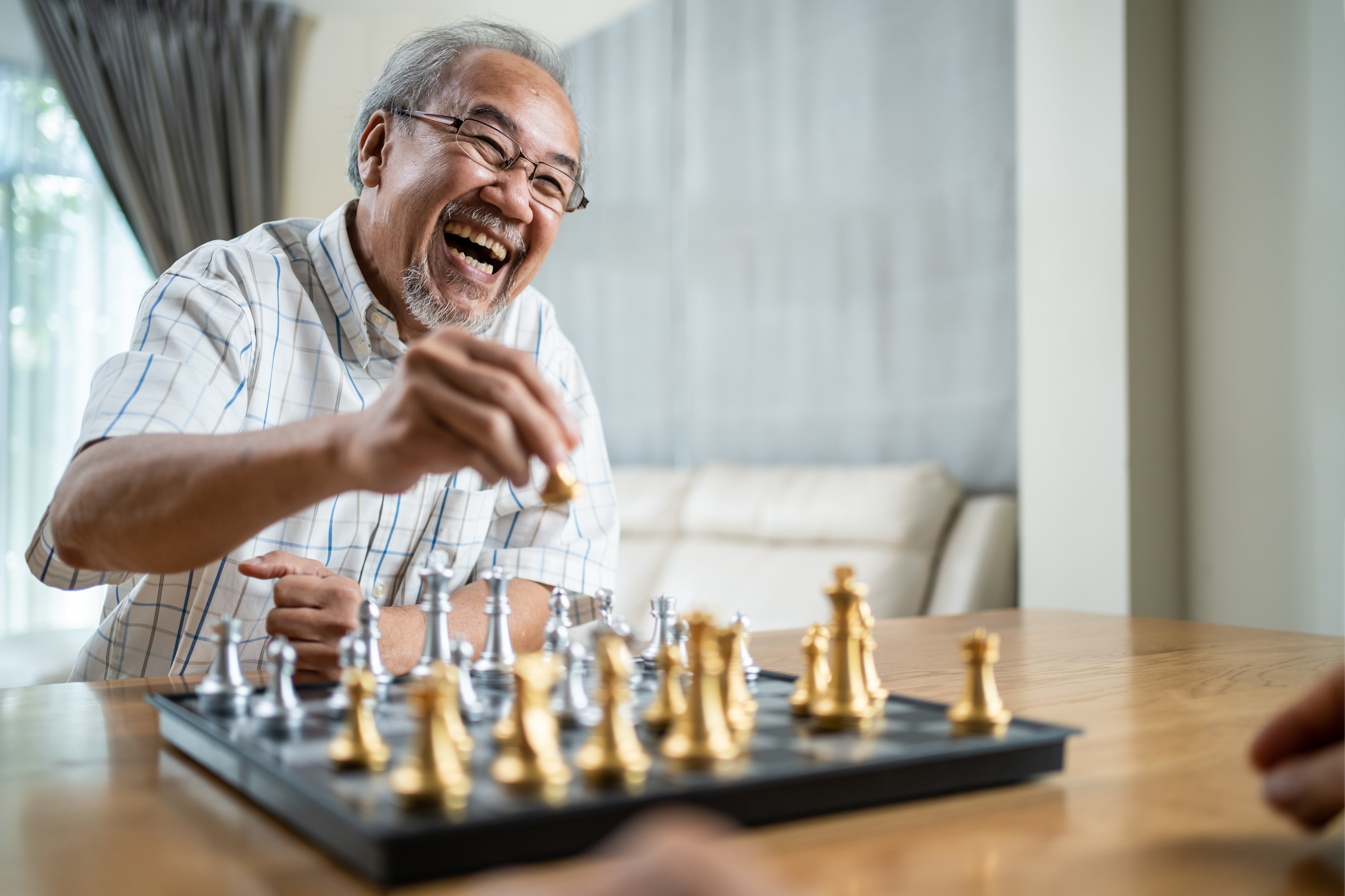 Man playing chess online on tablet computer Stock Photo