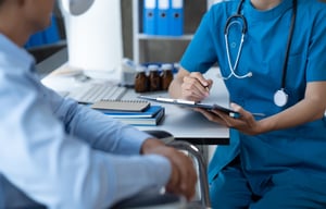 Doctor and patient sitting and talking at medical exam 