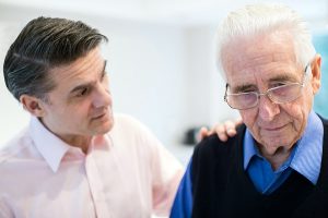 Senior Man With Adult Son At Home