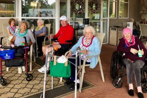 Group of seniors outside enjoying cups of shaved ice