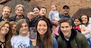 Family group photo with senior on video call