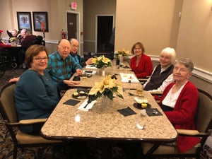 Group of Generations Senior Living residents and families eating holiday meal