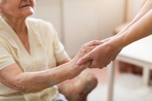 Nurse holding hands of senior patient