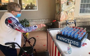 Elderly woman with walker playing ring toss