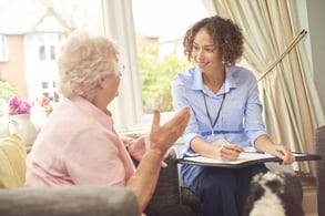 Female estate planner talking with a an elderly female homeowner