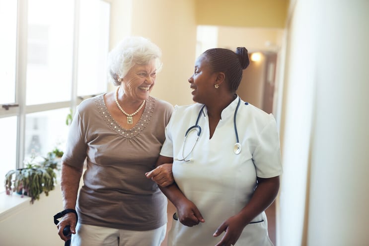 Medical provider walking with female senior