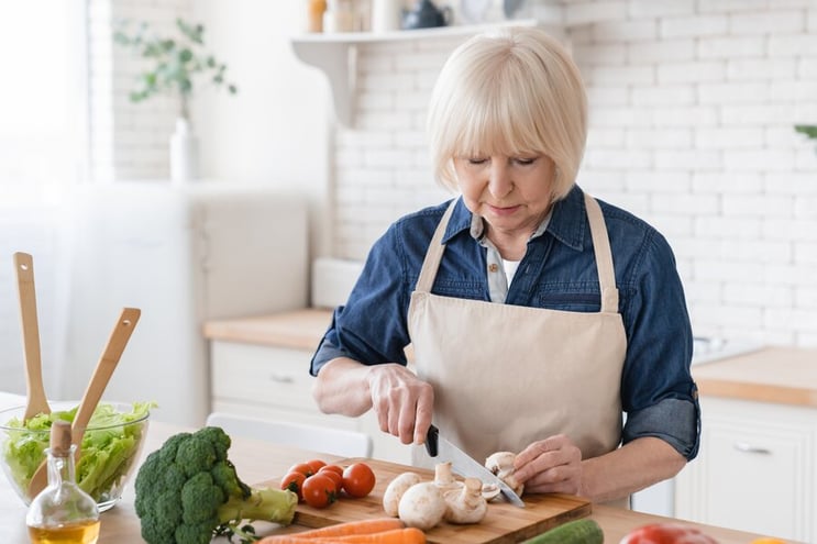 Senior female preparing food