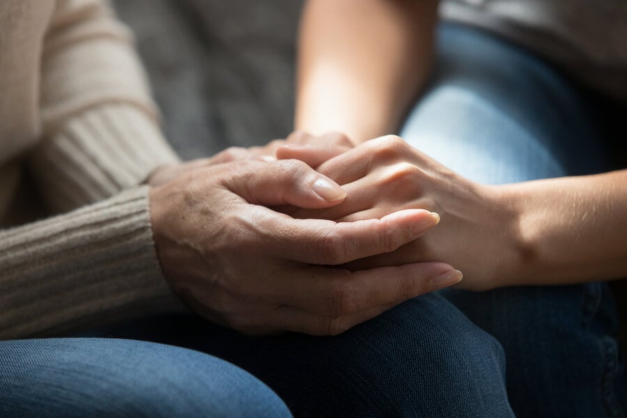 Two loved ones holding hands