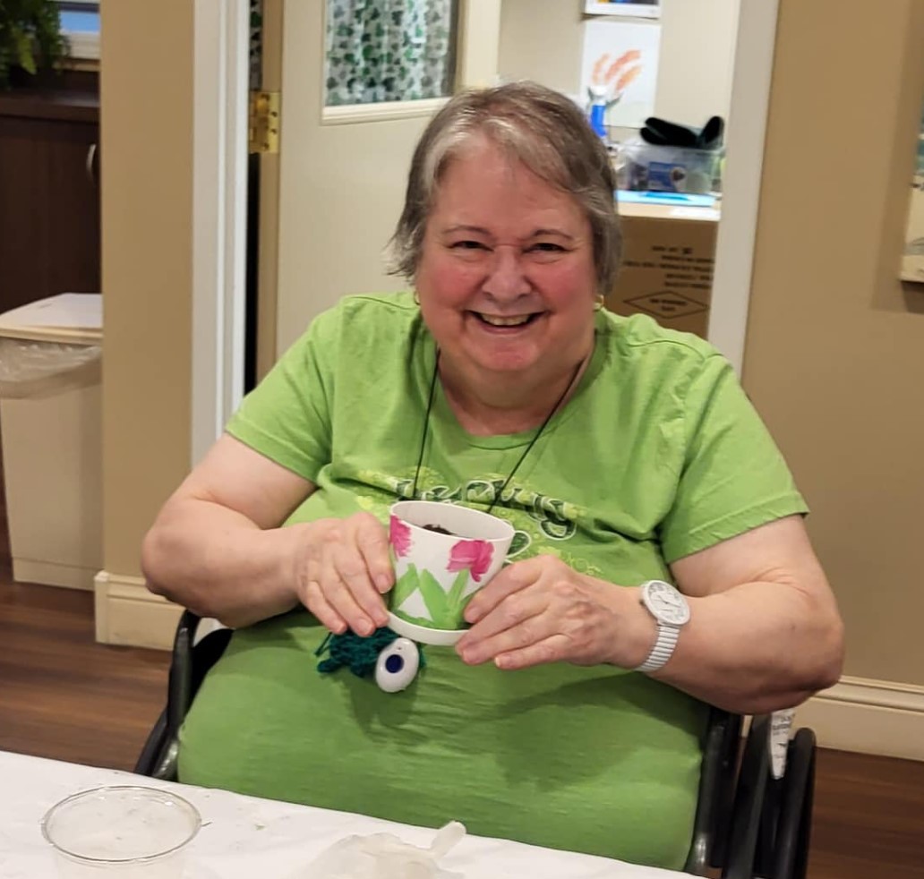 Senior woman holding painted pot